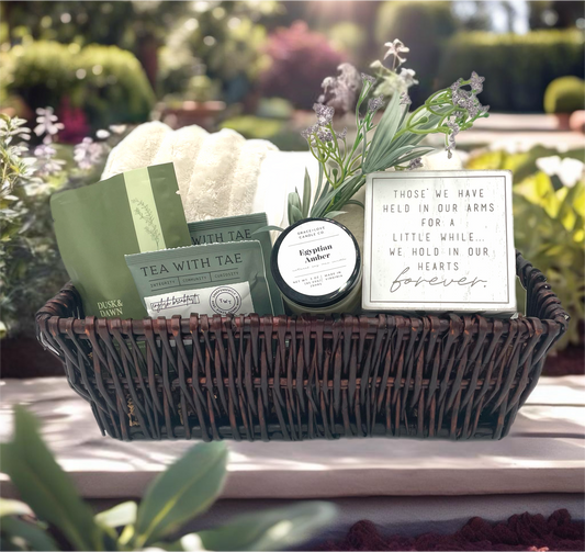 With Sympathy Gift Basket featuring a plush throw, candle, and comfort items