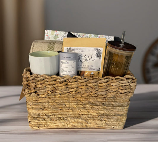 Cozy Night In Christmas gift basket with plaid throw, glass tumbler, candle, and puzzle