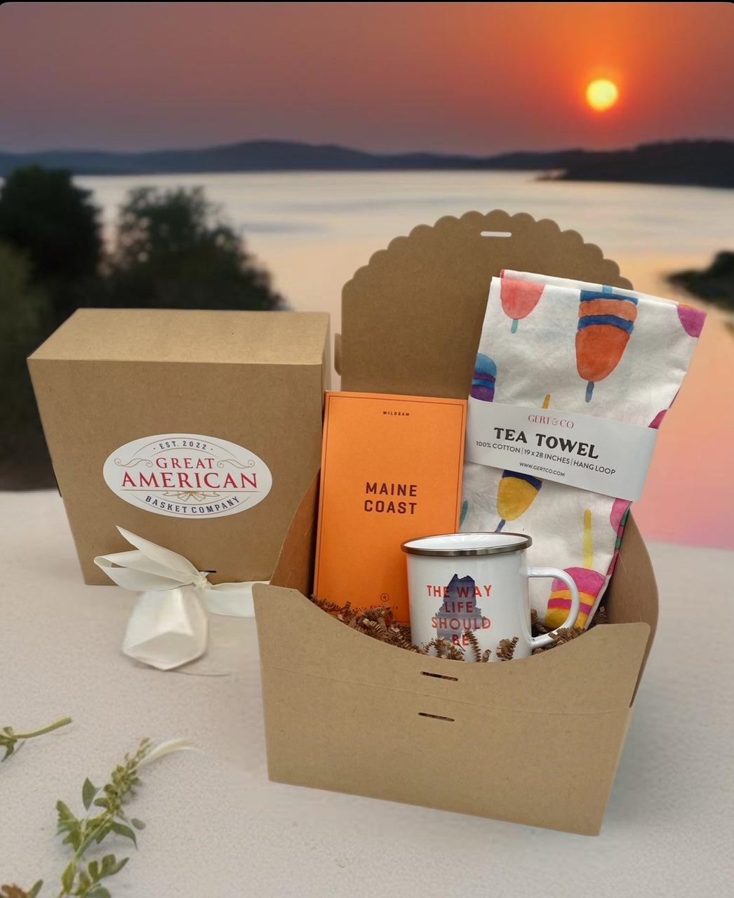 Maine gift basket from Great American Basket Company featuring a coastal tin mug, kitchen towel, and Maine Coast Field Guide